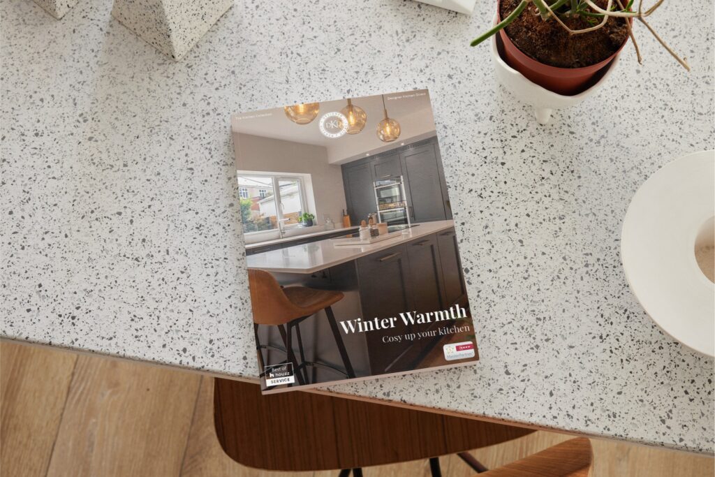 Winter kitchen brochure from Designer Kitchen Direct displayed on a polished granite countertop